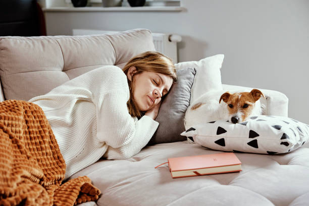 istock Woman Sleep With Dog On Sofa 1357834036