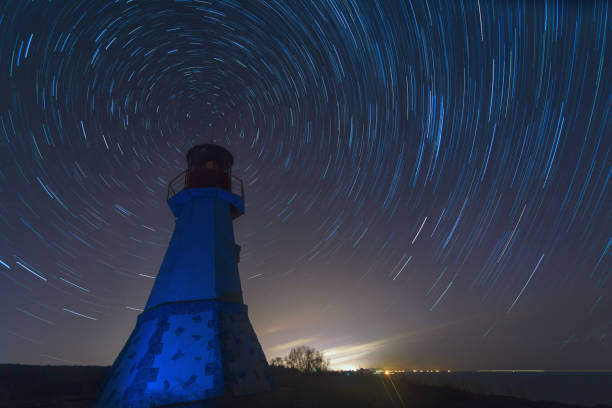 istock Lighthouse with night sky at background stars trails. 1357836670