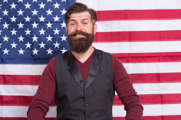 istock Bearded man school teacher teaching USA flag background, knowledge day concept 1357839041