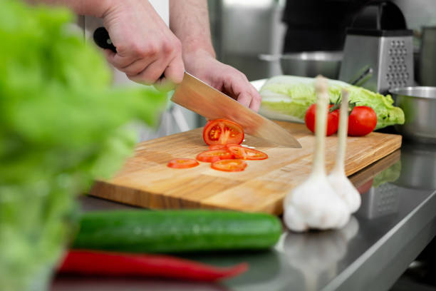 istock Chef in the kitchen cuts fresh and delicious vegetables for a vegetable salad 1357839159