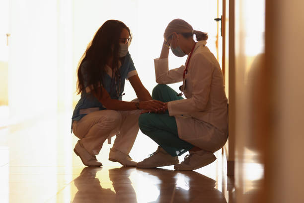 istock Tired medical worker after hard long surgery sitting on floor 1357839357