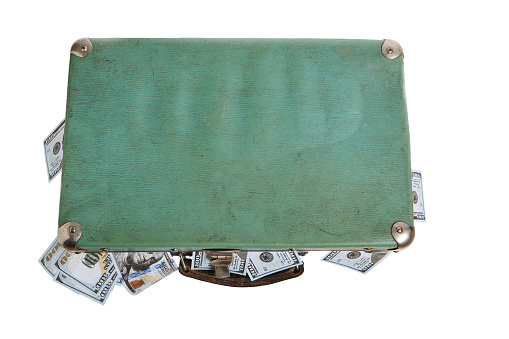 Old, green, retro vintage suitcase filled with money.On a white background, isolate