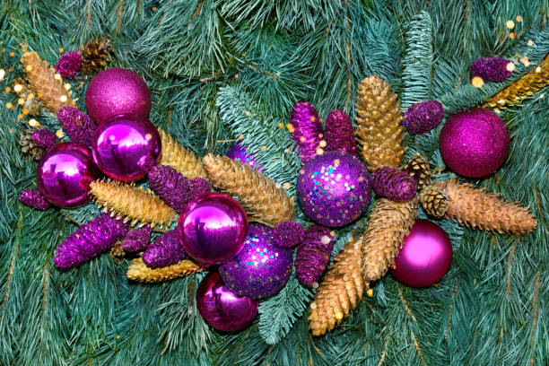 istock Christmas decoration: pink and lilac balls with cones and spruce branches. 1357840774