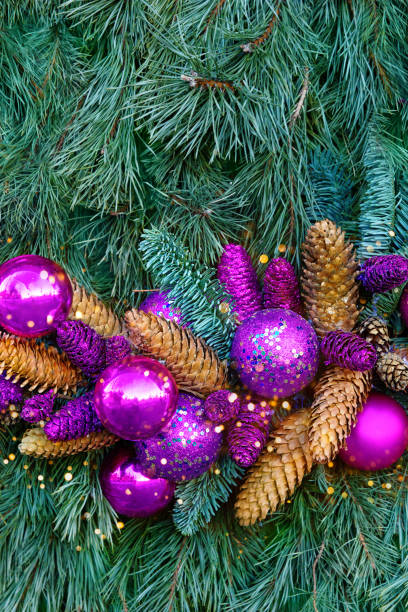 istock Christmas decoration: pink and lilac balls with cones and spruce branches. 1357840775