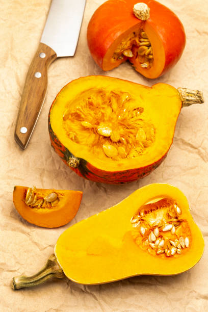 istock Sliced pumpkin and knife on brown paper. 1357843889