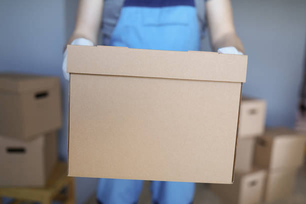 istock Worker loading cardboard boxes with owners belongings to new apartment 1357844978