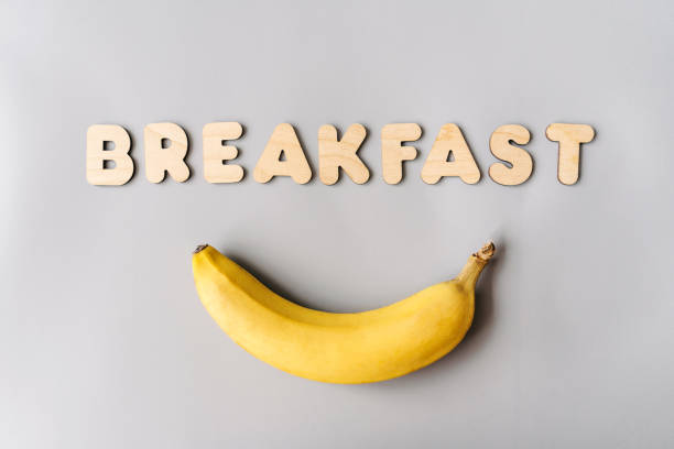 istock Bright breakfast, banana and text from wooden letters. 1357845162