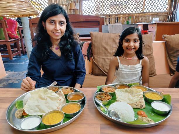 istock Mother and daughter having lunch at a restaurant 1357846001