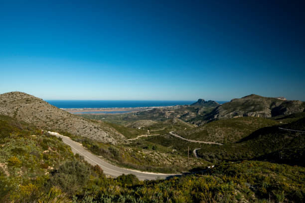 istock Winding mountain road between Pego village and Vall d'Ebo 1357846071