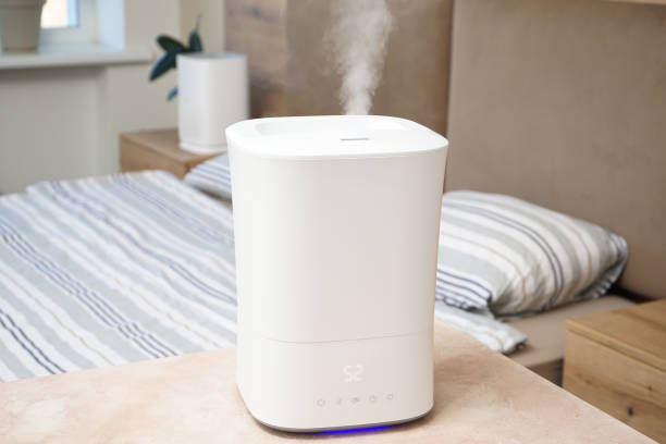 Modern humidifier in the bedroom. Ultrasonic humidifier in the house. stock photo