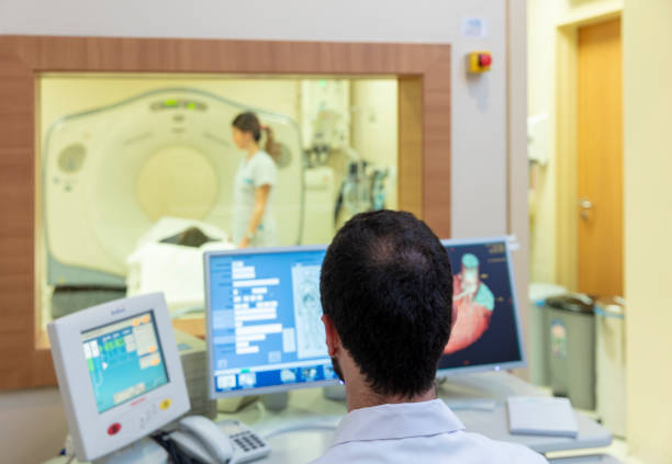 istock Doctor operating CT scanner in hospital 1357847904