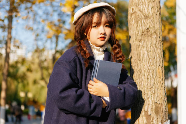 istock A woman is holding a book outside at sunset 1357847974