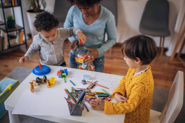 istock Nursery teacher and preschoolers playing 1357850112