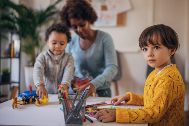 istock Nursery teacher and preschoolers playing 1357850145