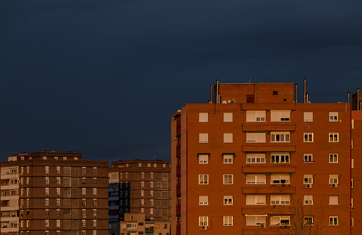 Residential buildings of Madrid, Spain, during sunset, against blue sky