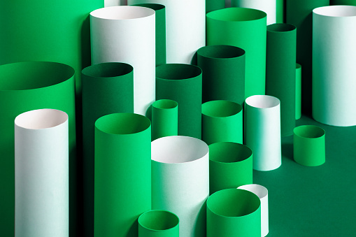 Green and white paper tubes organized into an abstract composition for infographics