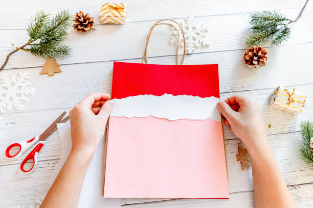 istock DIY Step-by-step guide instructions for Christmas paper bag for children. New year pack with Santa made of colored paper, glue and scissors. Fine motor skills. Winter holidays time. Handmade. Step 6 1357854713