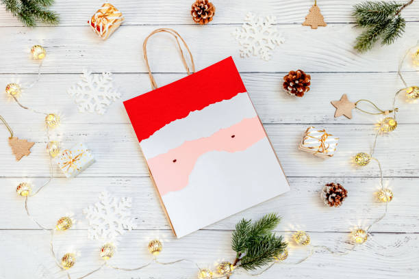 istock DIY Step-by-step guide instructions for Christmas paper bag for children. New year pack with Santa made of colored paper, glue and scissors. Fine motor skills. Winter holidays time. Handmade. Step 9 1357854753