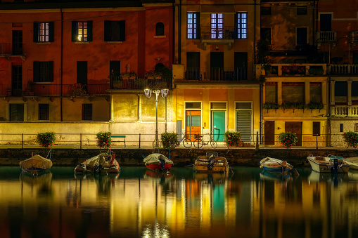 Small Italian town in the evening with a view of moored boats
