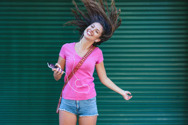 istock Woman dancing to the music 1357856122