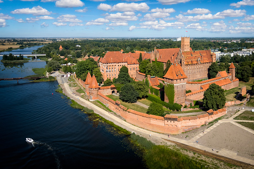 Malbork, Poland - August 14, 2021:Medieval Malbork Castle on the Nogat River, Poland.  Historical capital of the Teutonic Order - Crusaders