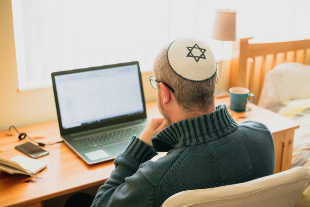 istock Jewish man wearing skull cap working from home 1357857433