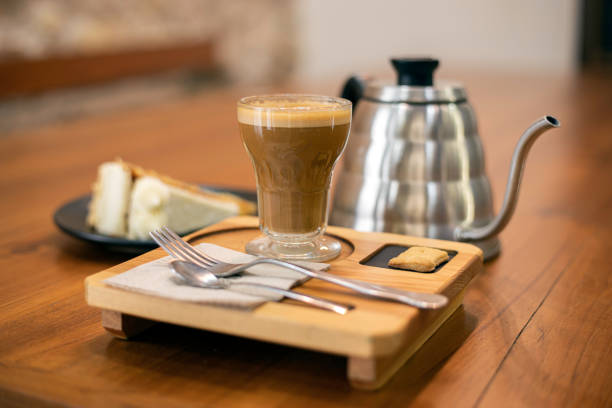 istock Coffee cup with a carrot cake on a table 1357858127