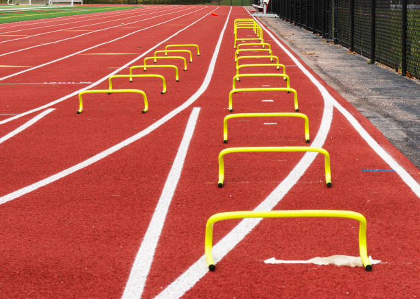 istock yellow mini hurdles lined up on a track 1357860754