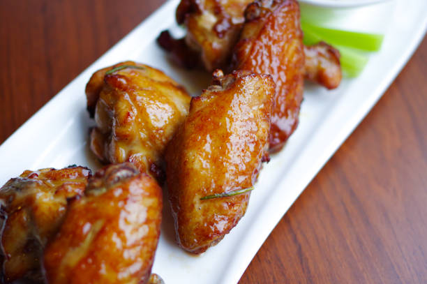 istock Roasted chicken wings and drumsticks on white plate 1357861502