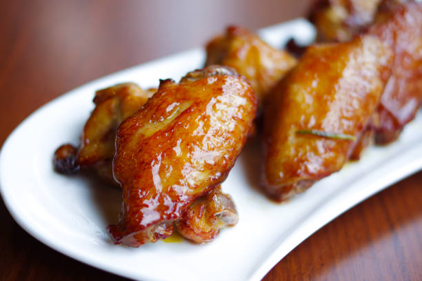 istock Roasted chicken wings and drumsticks on white plate 1357861503