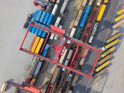 Cargo trains, trucks and a huge crane at railway freight terminal, Wels, Austria