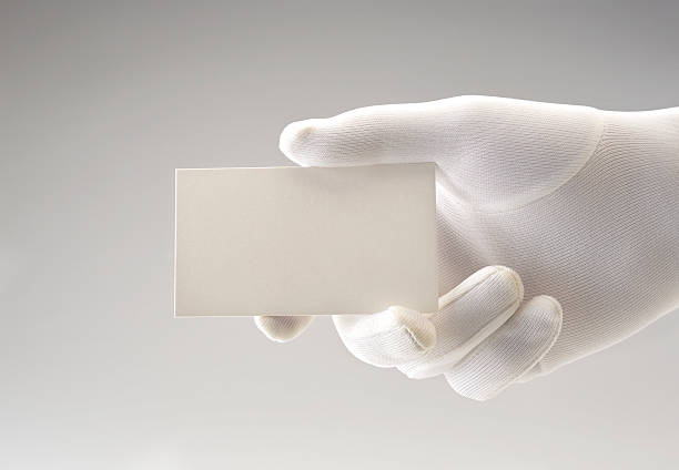 Business card in gloved hand stock photo