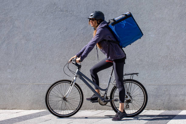 istock woman riding bicycle delivering order 1357862941