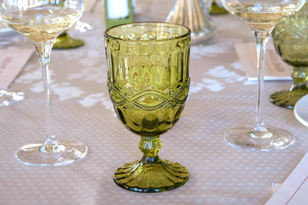 istock ‌Beautiful green wine glass standing on dining table 1357863020