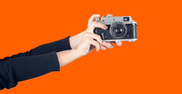istock Vintage Camera in female hand. 1357863036