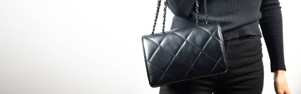 istock young elegant woman holding black bag 1357863140