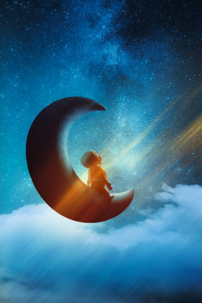 istock Little spaceboy sitting on a half moon in space and looking at stars and dreaming. 1357863343