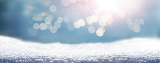 istock A cold winter snow landscape with sunny sky and sparkling light bokeh background 1357867460