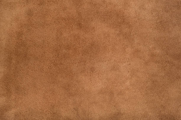 istock Brown suede leather texture background, genuine leather, top view. 1357868934
