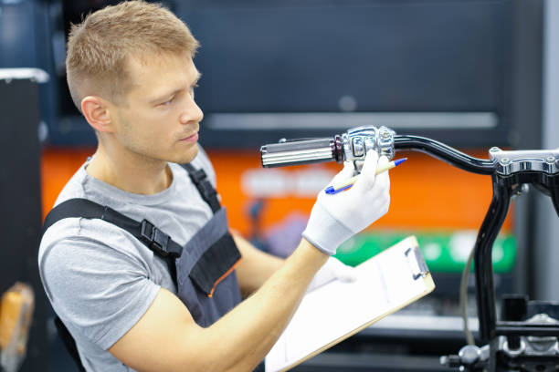 istock Young locksmith conducts diagnostics of motorcycle in service center 1357869024