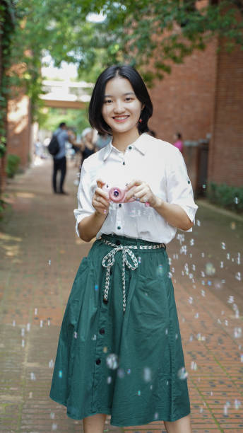 Happy happy blowing bubble girl teenage stock photo
