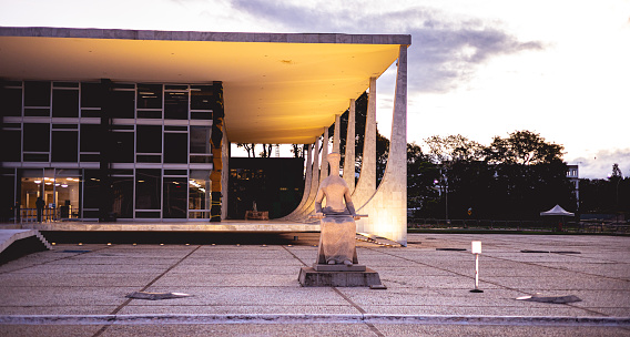 Photograph of the Federal Supreme Court ( STF - Supremo Tribunal Federal )  in Brasilia, federal capital of Brazil. The STF was designed by Oscar Niemeyer and a sculpture of justice by the artist Alfredo Ceschiatti. Brasilia, Federal District - Brazil. December, 04, 2021.