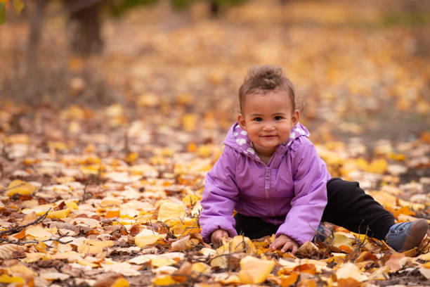 Cute child having fun in autumn park.