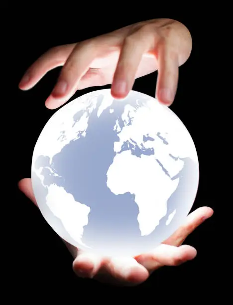 Photo of Hands holding levitating Earth model on black