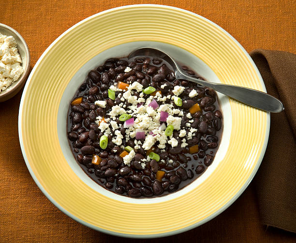 Black Bean soup sprinkled with Queso crumbled cheese stock photo