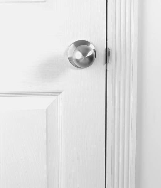istock White door with doorknob 135787103