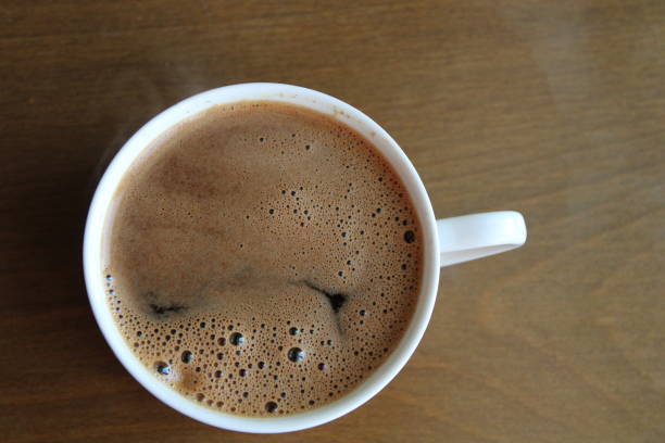 istock Cup of coffee on wooden table, top view 1357873147