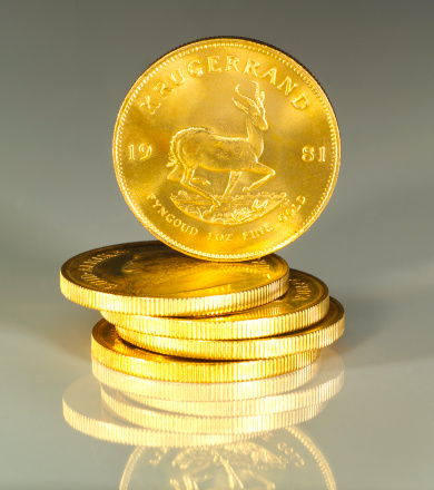 South African Krugerrand 1oz Gold Coins on reflective surface