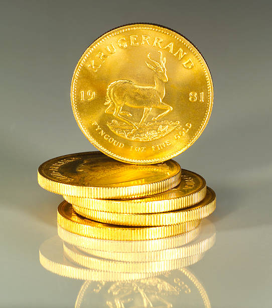 South African Krugerrand 1oz Gold Coins stacked with reflection stock photo