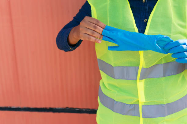 istock Industry worker taking off her gloves 1357876631